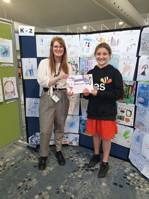 a child and library staff during book week 