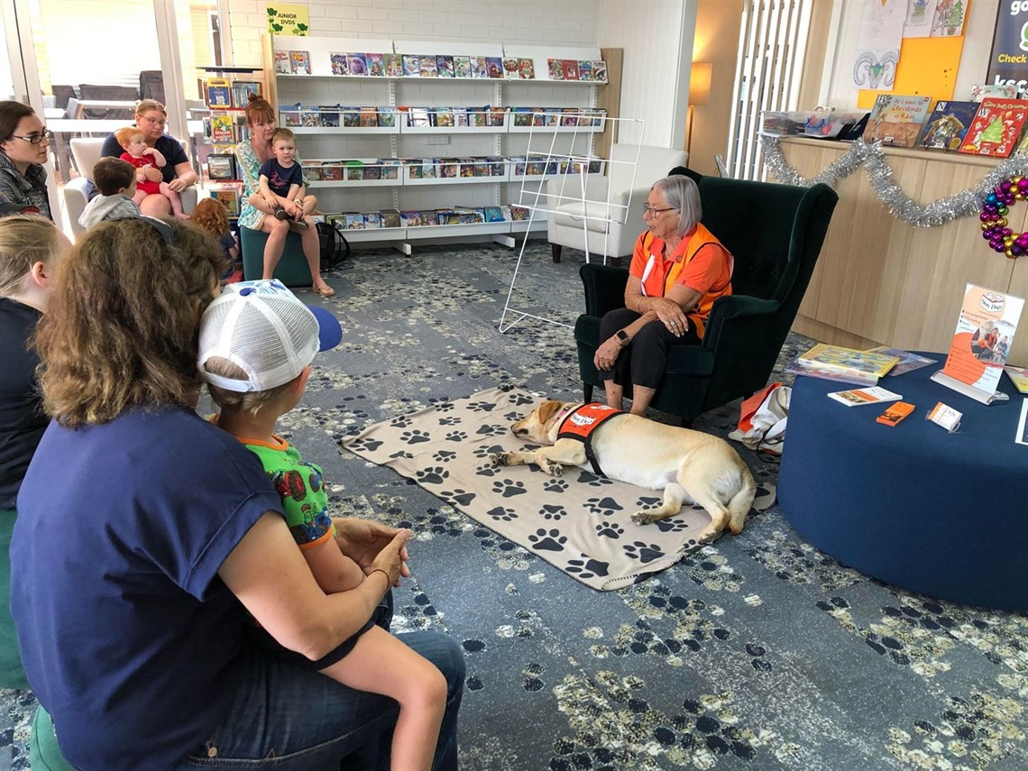 reading a book with a dog