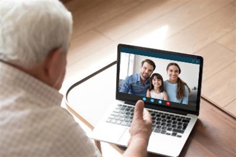 grandfather connecting with family on laptop