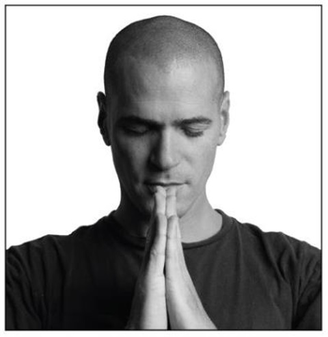 man with hands together in prayer position