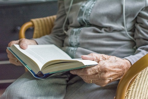 older person reading a book