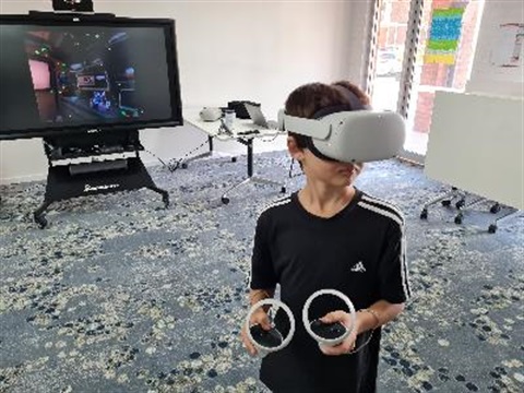 boy using virtual reality equipment